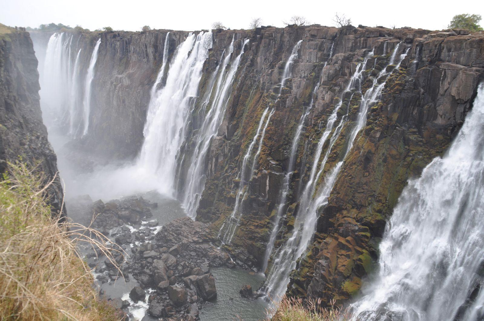 Water pouring over the basalt cliffs of Victoria Falls into the gorge below